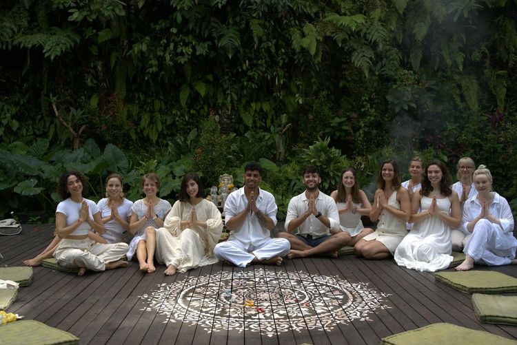 A diverse group practicing yoga outdoors, fostering unity and relaxation in nature.