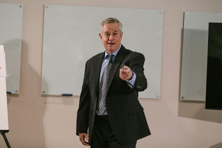 Professional presenter delivering a business talk in a conference room.