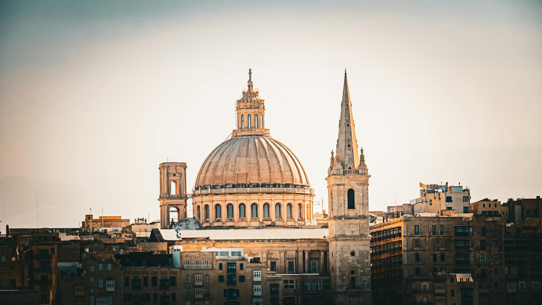 Captivating skyline of Valletta featuring the famous dome and architecture at sunset. Captivating skyline of Valletta featuring the famous dome and architecture at sunset.