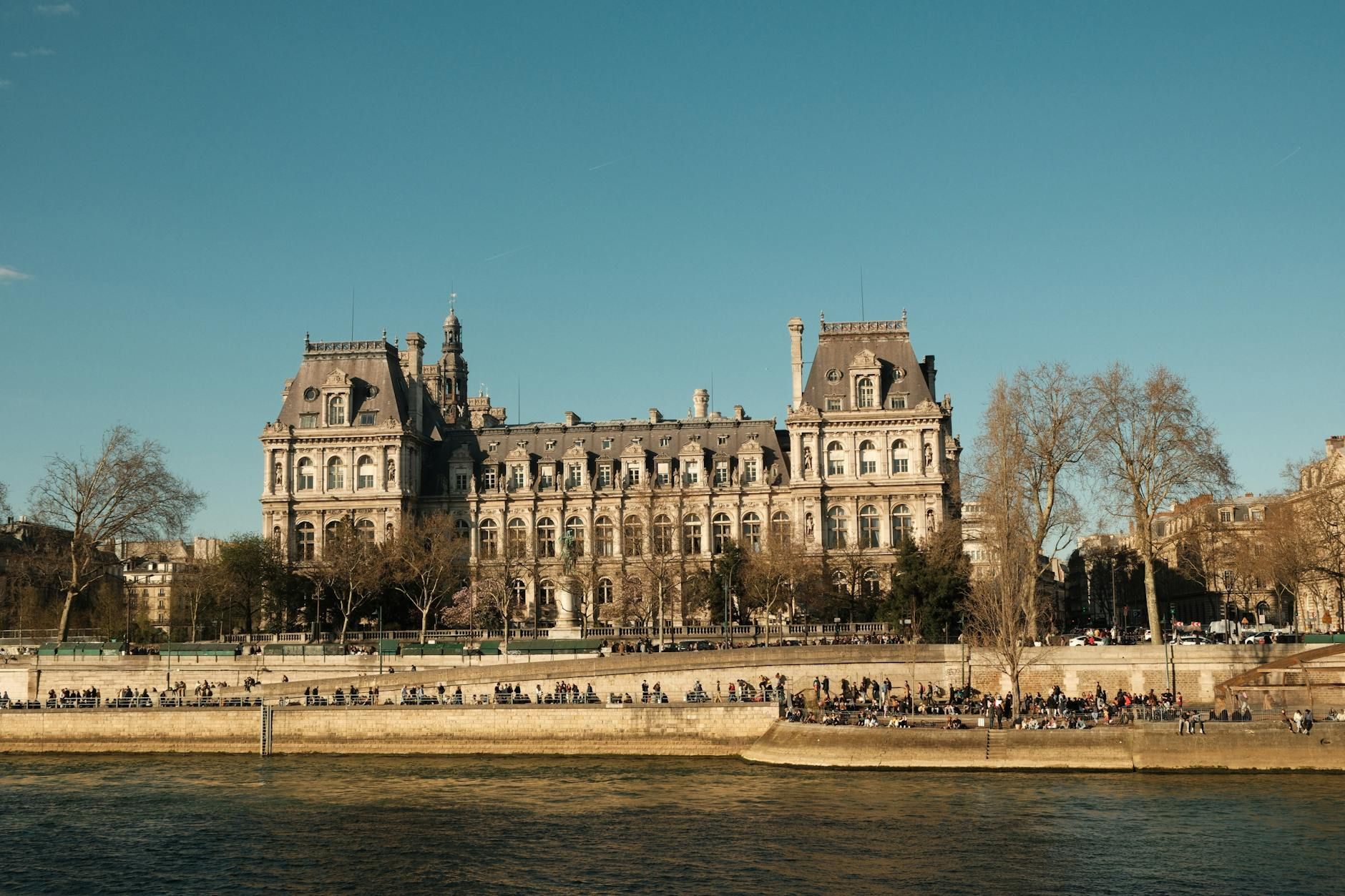 Elegant view of a classic Parisian building along the Seine River on a clear day. Elegant view of a classic Parisian building along the Seine River on a clear day.