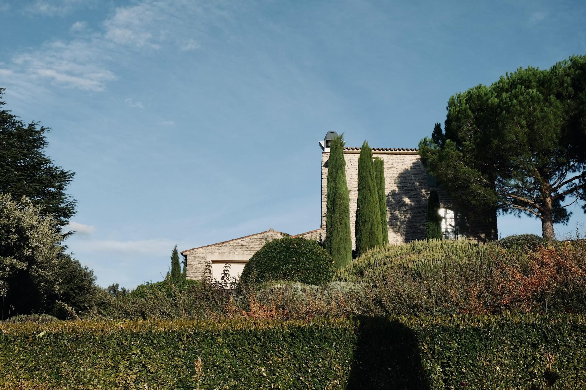 A beautiful stone house surrounded by a lush garden in Provence, France. A beautiful stone house surrounded by a lush garden in Provence, France.